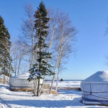 An exterior view of two luxury yurts used during Nova Scotia winter getaways.